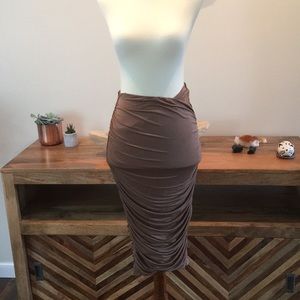 High rise, form fitting, mid length skirt